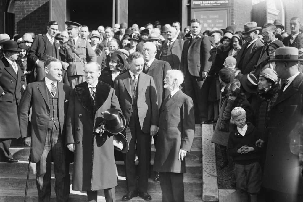 President and Mrs. Coolidge attended Thanksgiving Day service at the First Baptist Church in Virginia. Glass negative by Harris & Ewing, 1928. Library of Congress Prints & Photographs Division.

Photograph shows, left to right: Governor Angus McLean of North Carolina; President Coolidge; Mrs. Coolidge; Governor Harry Byrd of Virginia; Rev. George L. Petrie of the Charlottesville Ministerial Associate; and Rev. J.W. Moore, Pastor of the First Baptist Church.

https://www.loc.gov/item/2016889105/